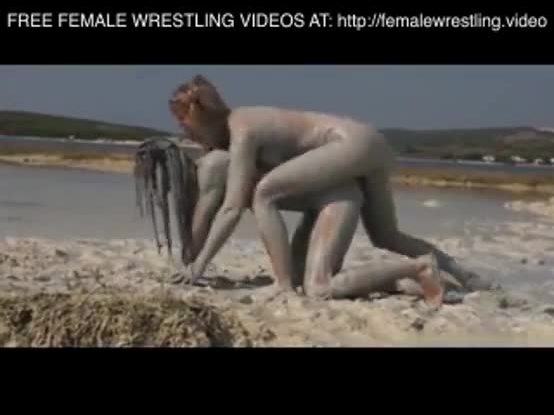 Girls wrestling in the mud