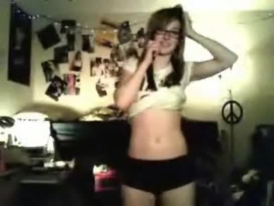 Nerdy young babe strips and teases while talking on phone